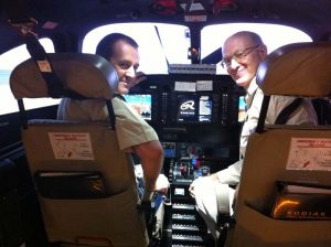 Steve Geis, a pilot in Papua New Guinea, and JAARS flight instructor Mark Wuerffel in the flight simulator at Spokane Turbine Center.