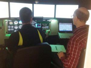 YAJASI pilot Kars Kroneman and instructor Mark Wuerffel simulate IFR conditions in our Redbird flight simulator.