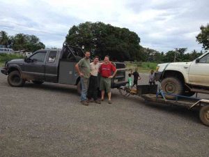 (l to r) Evan Halferty and Jeremy Lott with Steve Johnson and the renovated truck that rescued the Johnsons.