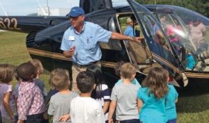 A JAARS pilot introduces our helicopter to a group of Florida youngsters.