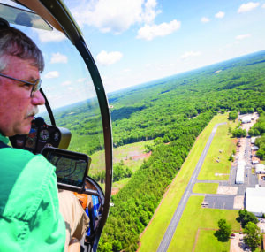 Jeff Johnson takes passengers on helicopter ride in JAARS' Robinson R44 helicopter around the JAARS center in Waxhaw NC. This very R44  helicopter was orginally in service in Cameroon.